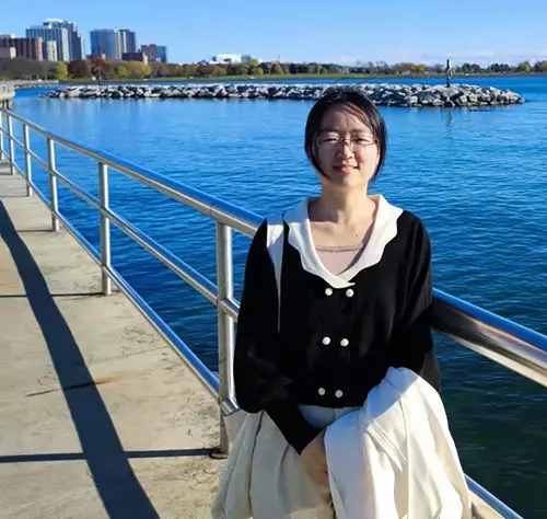 A woman standing by the water